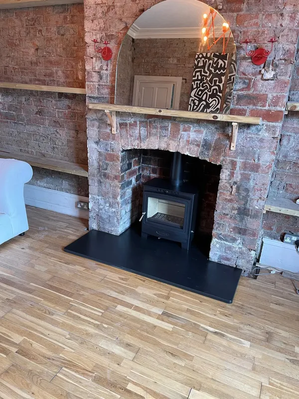 Arada Solution 5 Widescreen stove in traditional brick chimney